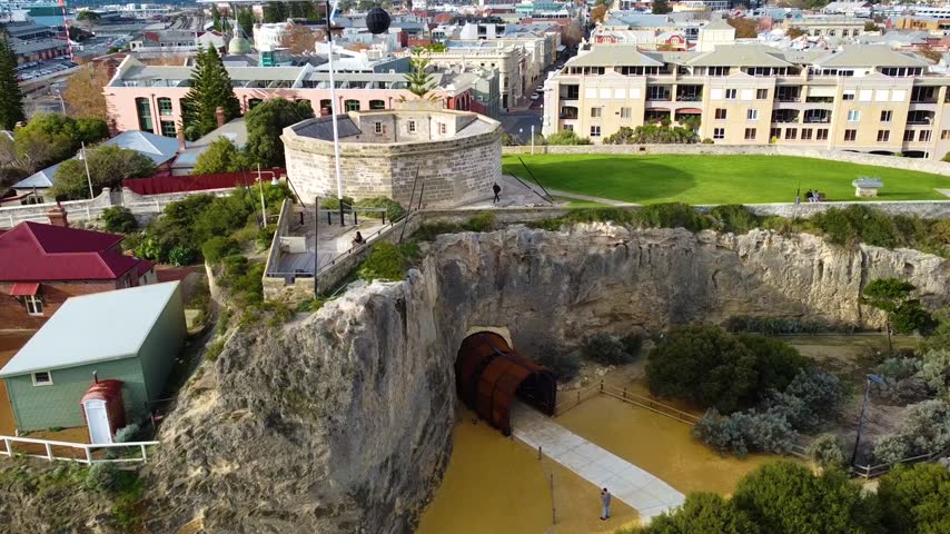 Aerial shot slowly flying over the round house, the oldest public building in western australia, with the whalers tunnel below