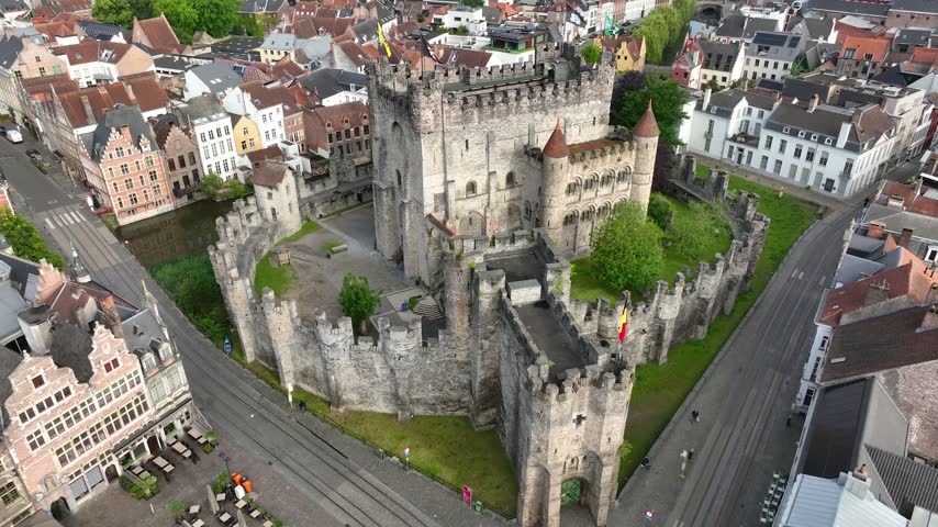 Aerial view of Ghent, Belgium, featuring the medieval Gravensteen Castle surrounded by historic architecture, canals and charming streets in the heart of the old city.
