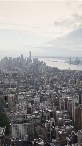 Aerial time lapse view of New York City skyline as daylight fades into twilight and dark night sky over Manhattan skyscrapers and urban streets capturing dynamic metropolitan lighting changes.