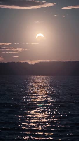 Partial solar eclipse over a lake in Kouvola, Finland August - 2026
