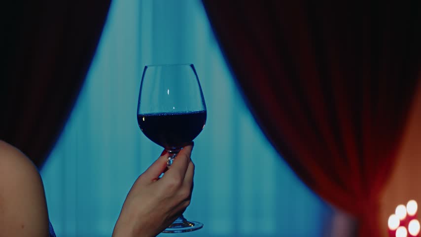 gothic woman red-haired mystical beauty red hair close-up, hand holding glass of red wine. Dark night room. Fantasy lady sexy vampire girl evil goth back rear view evening black dress art old style 4k