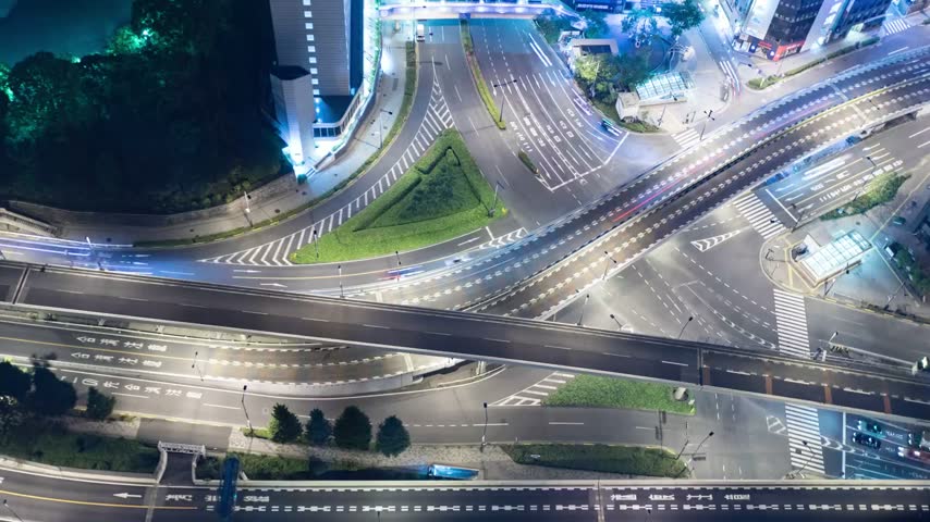High angle night time lapse of city road traffic and street lights.