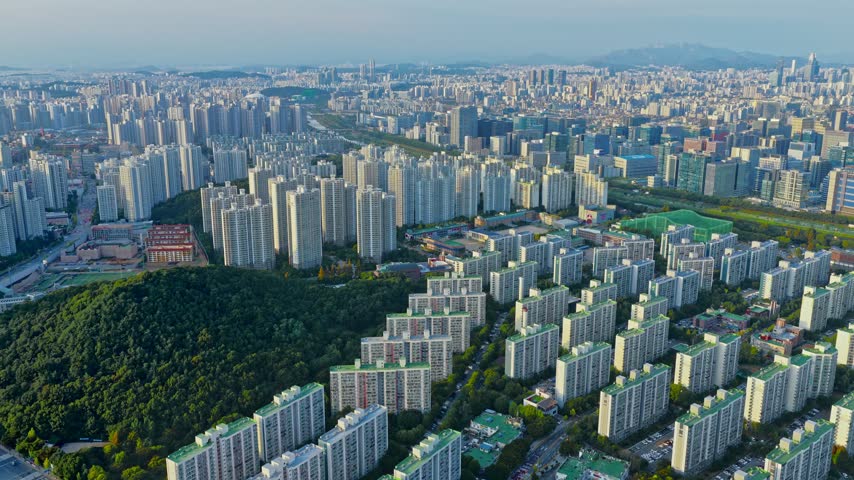 Seoul Metropolitan Area Cityscape With Apartment Buildings And Wooded Hill