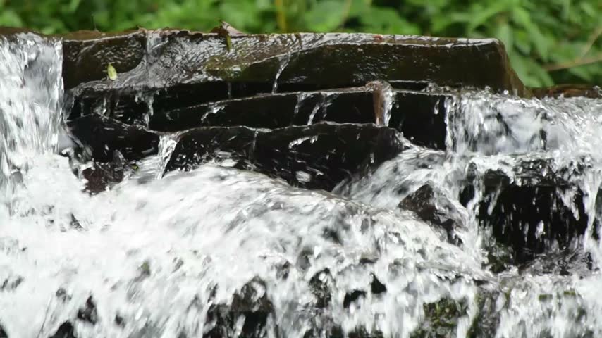 Beautiful Waterfall Cascading Over Natural Rocky Cliff
