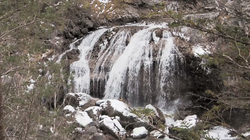 Powerful waterfall and tranquil mountain stream