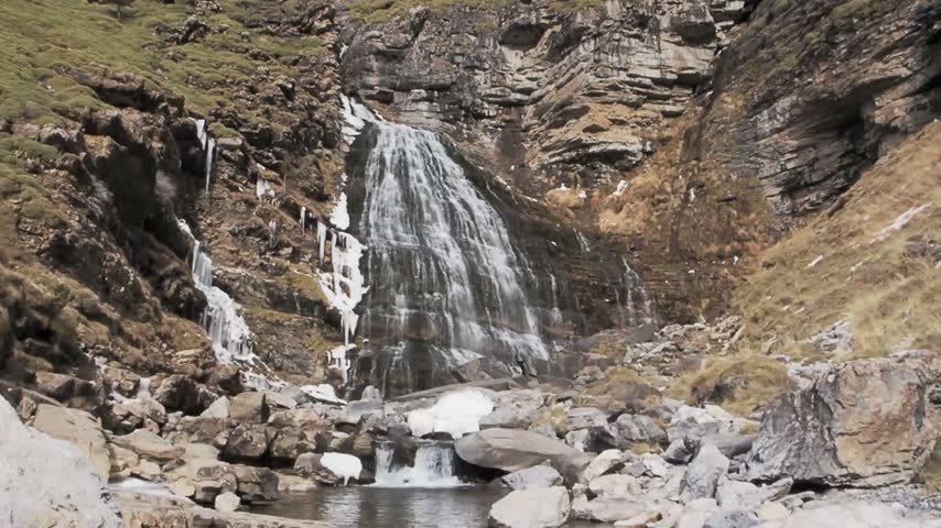 Powerful waterfall and tranquil mountain stream