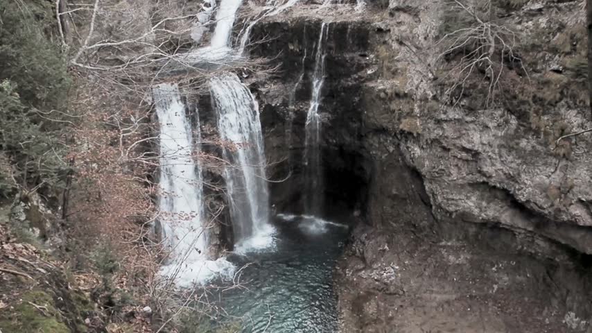 Powerful waterfall and tranquil mountain stream