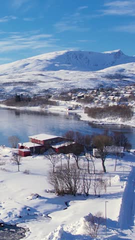 Experience the breathtaking beauty of Tromso, Norway during winter. Discover the serene beaches, icy waters, and snow-capped mountains and fishing village.