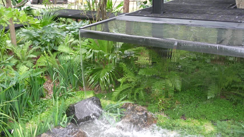 small waterfall from glass floor in the yard recreation area 