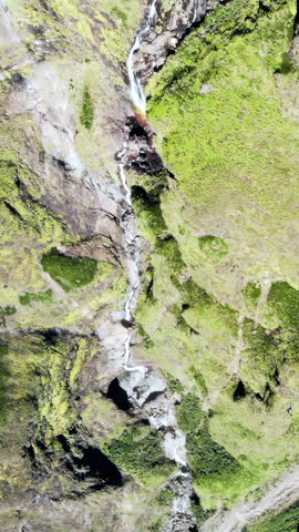 Aerial view of a moss-covered rock cliff