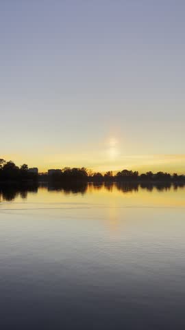 sunset over the lake with tree reflections