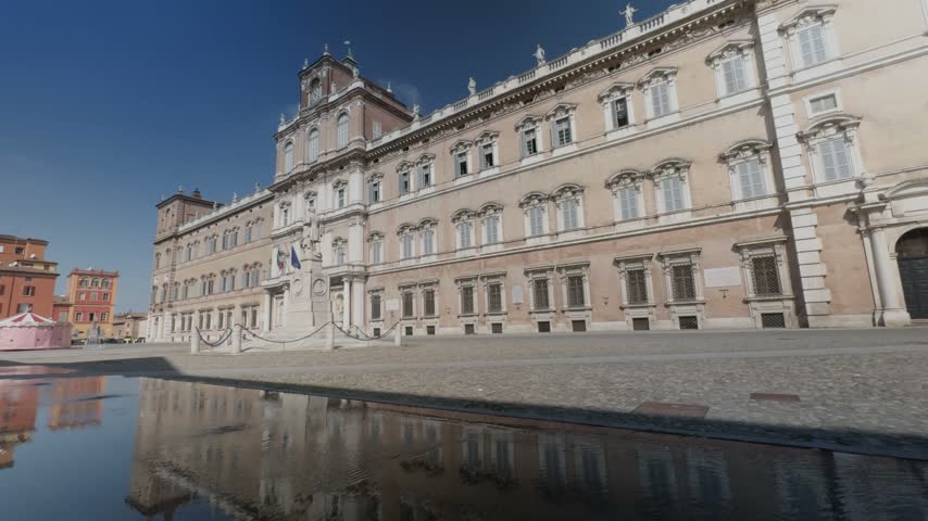 Ducal Palace in Modena, Italy, grand Baroque facade framed by arcade arches and columns, sunlit courtyard and piazza showcasing historic architecture and civic heritage