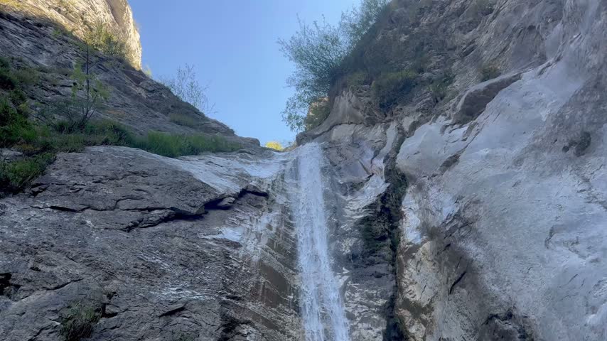 Italy, Bernezzo. September 30, 2026. 
Small Mountain Waterfall Cascading Between Rocky Cliffs in Nature.  Author: Djundiet A.