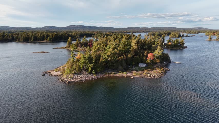 Aerial View of Serene Rocky Island with Cabin and Dock on Calm Lake - Northern Ontario