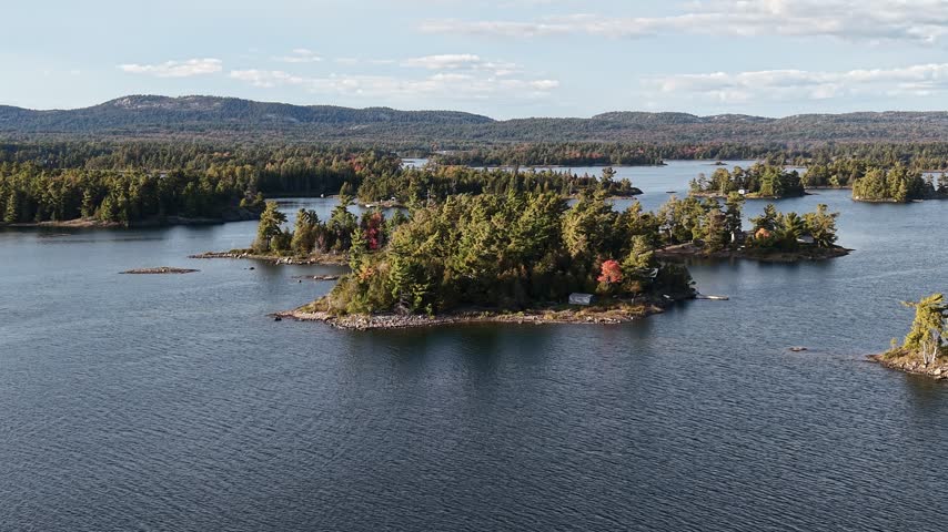 Aerial View of Serene Rocky Island with Cabin and Dock on Calm Lake - Northern Ontario