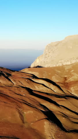 Rocky mountain slope with cliffs and distant horizon