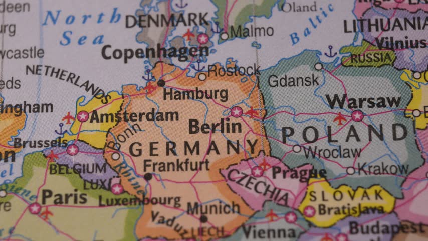 Paper tag with Visit Next text placed on map of Europe for travel planning.