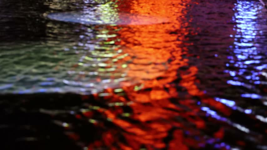 Stockholm, Sweden Bright city lights reflected in the fountain at night on Sergels Torg. 