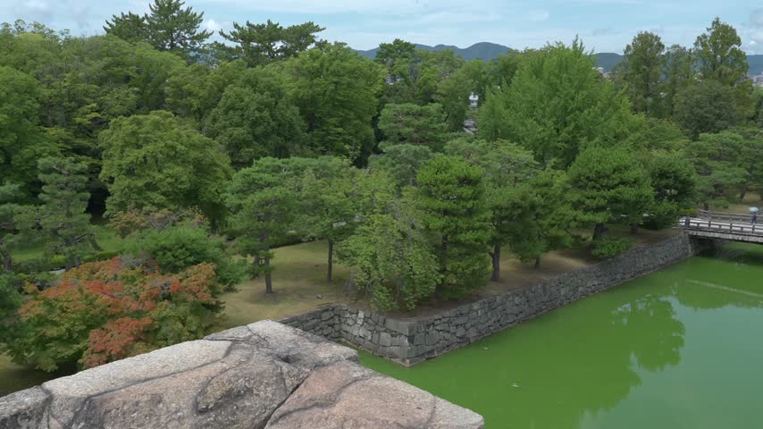 Nijo Castle moat with stone ramparts and bridge, historic samurai fortress in Kyoto, Japan