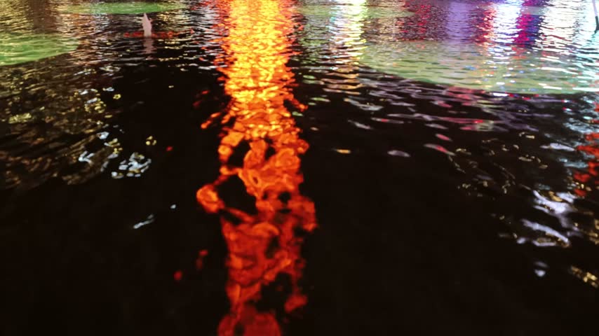 Stockholm, Sweden Bright city lights reflected in the fountain at night on Sergels Torg. 