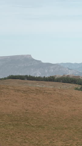 Solitary Red Cabin Nestled Among Gentle Hills. Peaceful Moorland Scene With Distant Ridges And Calm Waters. Creative
