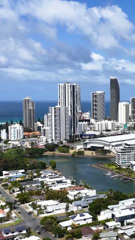 High angle aerial shot of Surfers Paradise skyline, canals, and ocean in Gold Coast, Australia.