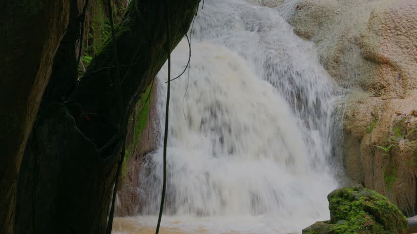 Serene Waterfall Cascading Over Mossy Rocks