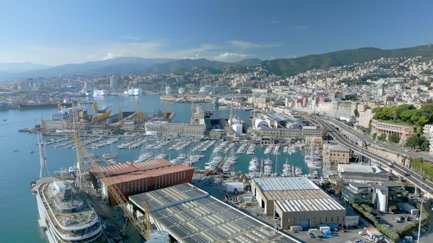 High angle aerial view overlooking the scenic port and coastal highway of Genoa in Italy.
