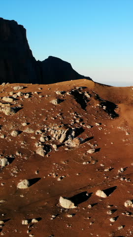 Rocky mountain slope with cliffs and distant horizon