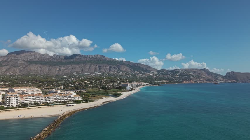 The Costa Blanca coastline in Albir and Altea, Spain. View the Mediterranean Sea, beach, and mountains on a sunny day.