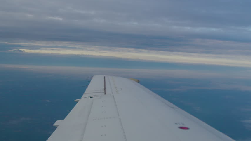 View Of Airplane Wing While Flying.