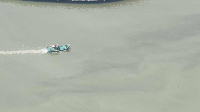 Small Boat Moving Along River