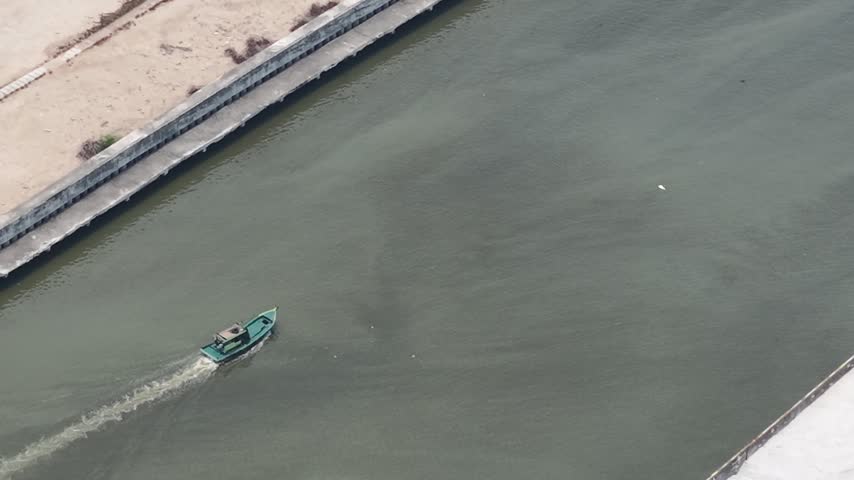 Small Boat Moving Along River
