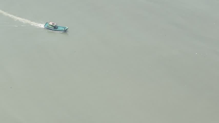 Small Boat Moving Along River