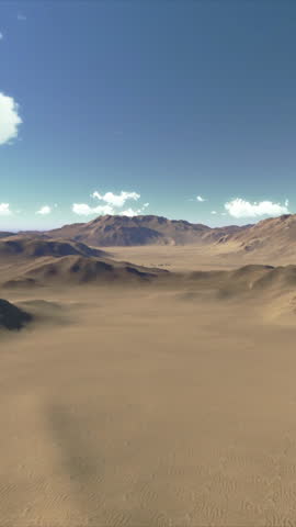 Low altitude drone flight over a vast, arid desert with distant mountains under a clear blue sky