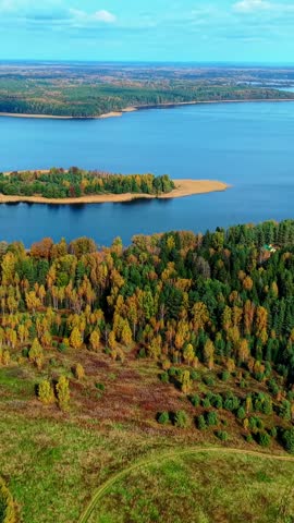 Aerial view of vibrant autumn landscape with colorful trees and serene lakes