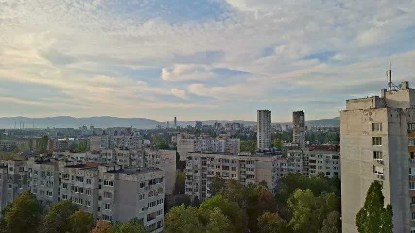 Wide high angle shot of city architecture and apartment buildings on sunny day