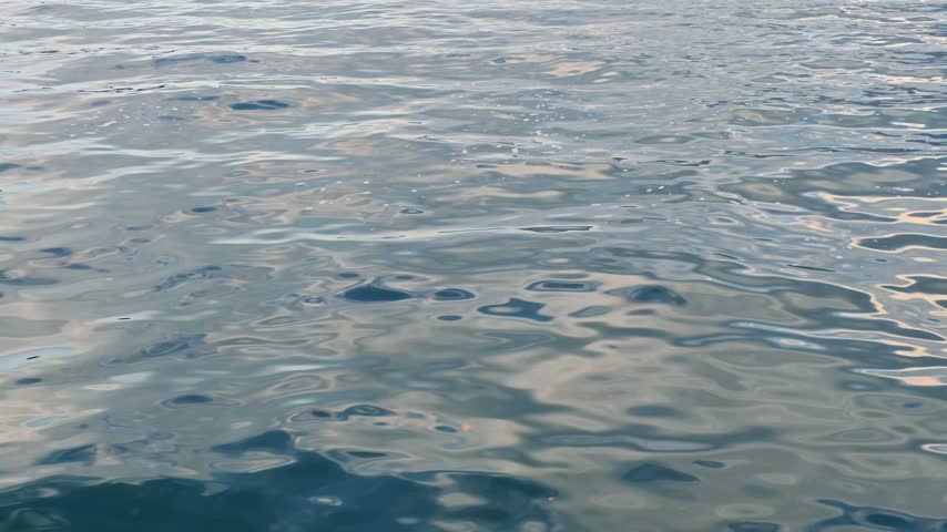 Abstract water patterns glistening over the surface of Lake Lucerne, Central Switzerland; A vital water source that is purified used as drinking water in the surrounding areas.