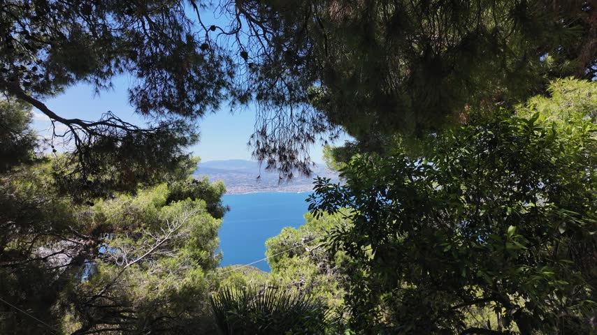 Holy Monastery of Saint Patapios, Loutraki, Corinthia, Greece - July 6th, 2026 - footage of the christian orthodox monastery situated on the slopes of Mountain Geraneia, pine trees, caves, small square and the churches during the sunny weather