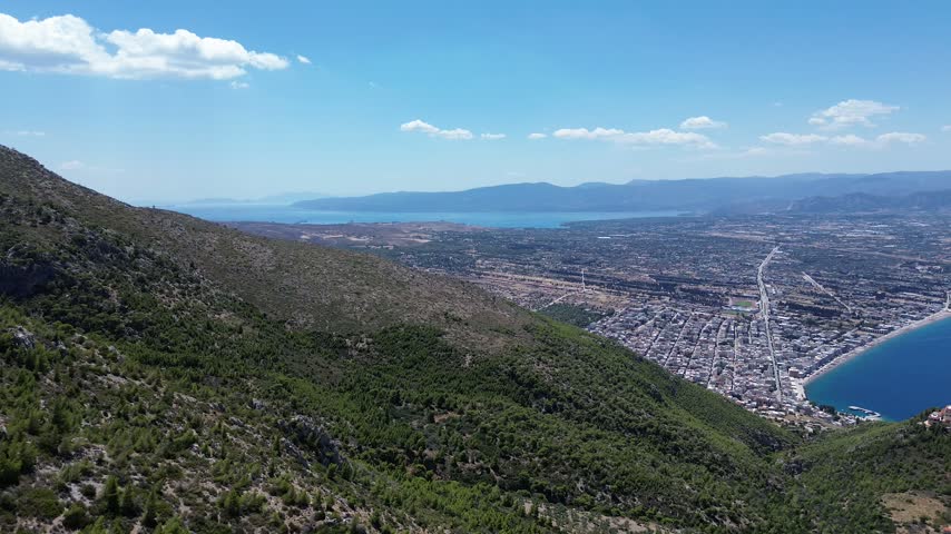 Holy Monastery of Saint Patapios, Loutraki, Corinthia, Greece - July 6th, 2026 - footage of the christian orthodox monastery situated on the slopes of Mountain Geraneia, pine trees, caves, small square and the churches during the sunny weather