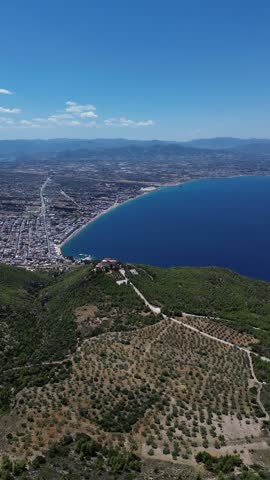 Holy Monastery of Saint Patapios, Loutraki, Corinthia, Greece - July 6th, 2026 - footage of the christian orthodox monastery situated on the slopes of Mountain Geraneia, pine trees, caves, small square and the churches during the sunny weather