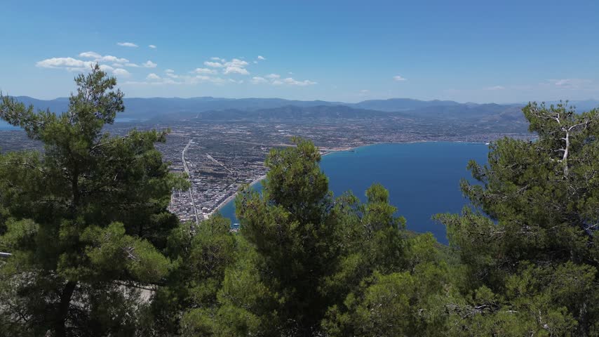 Holy Monastery of Saint Patapios, Loutraki, Corinthia, Greece - July 6th, 2026 - footage of the christian orthodox monastery situated on the slopes of Mountain Geraneia, pine trees, caves, small square and the churches during the sunny weather
