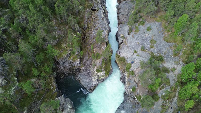 People Standing on Cliff Edge Above Ridderspranget Gorge in Norway
