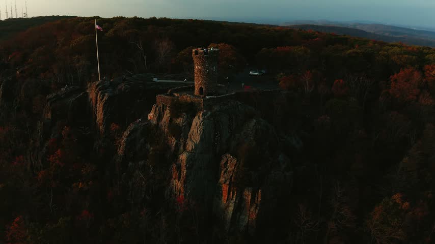 Castle Craig tower in Meriden Connecticut set against a sweeping mountainscape with city views below