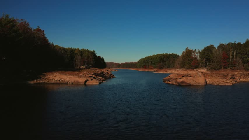 Wide aerial drone shot of Chatfield Hollow lake in Higganum Connecticut with surrounding forest