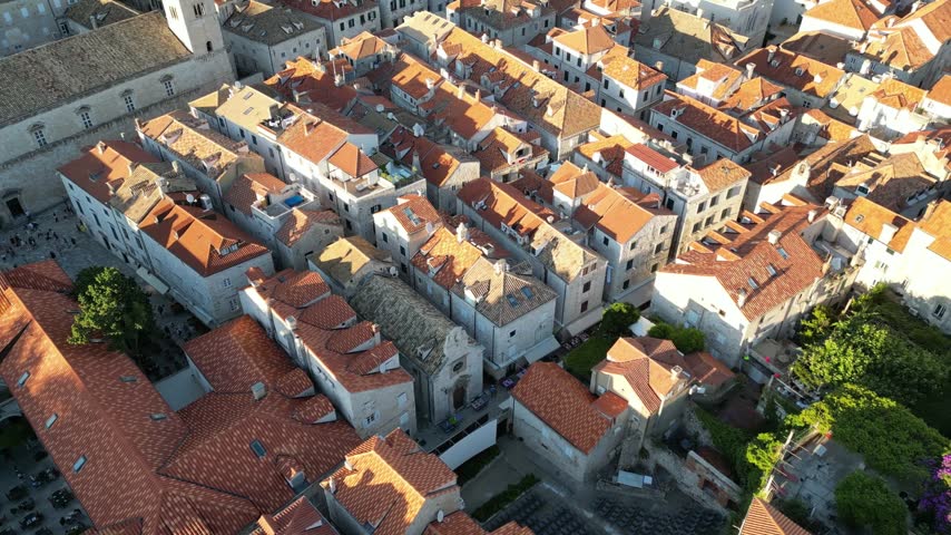 Large Onofrio Fountain, Franciscan Monastery, And Terracotta Roofs Along Stradun In Dubrovnik Old Town, Croatia. - aerial shot
