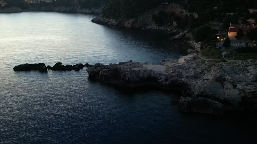 Rocky Shoreline And Dance Beach Along The Calm Adriatic Sea In Dubrovnik, Croatia. - aerial shot