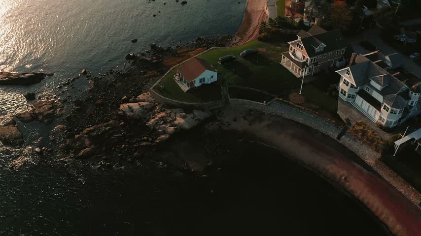 Beautiful sunset over the Connecticut coastline with warm colors reflecting across a New England bay