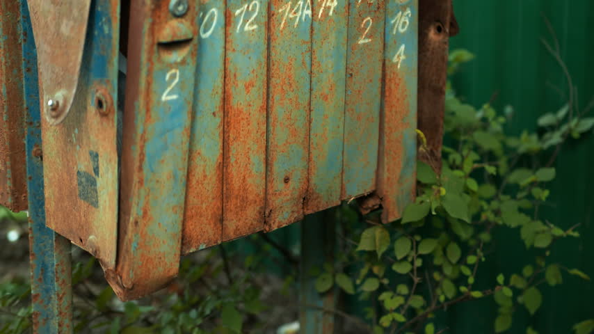 Vintage Mailboxes against long grass background in the village. outdoor mail.