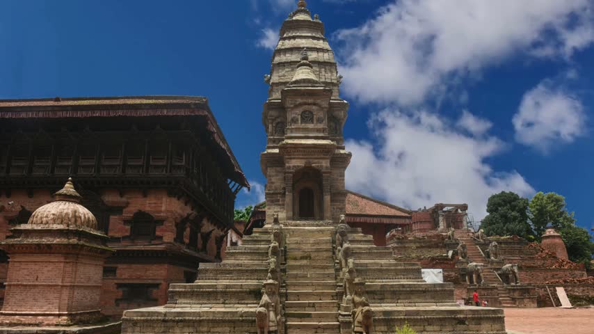 Kathmandu, Nepal 
Group of people visiting Bhaktapur Durbar Square. Bhaktapur Durbar Square is a former royal palace complex located in Bhaktapur, Nepal.Bhaktapur,Nepal, October, 26, 2012, Nepali  Scene: woman waling near ancient hindu temple of Fasideg on ancient Durbar square.  In may 2015 square partially destroyed during the earthquake